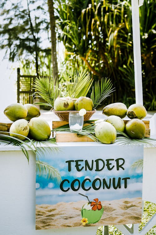 A tropical themed wedding with a sign that says tender coconut