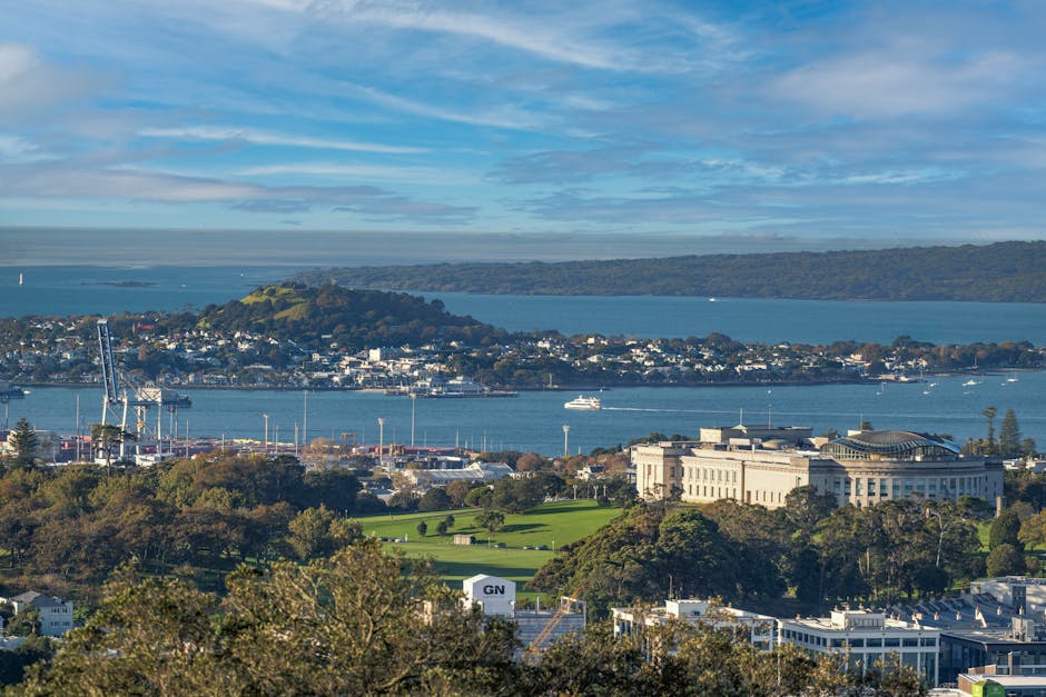 A panoramic view of Auckland, New Zealand, showcasing its harbor and cityscape.