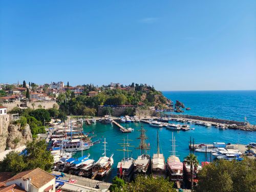 Free A breathtaking view of Antalya's harbor with boats and clear blue sea under a bright summer sky. Stock Photo