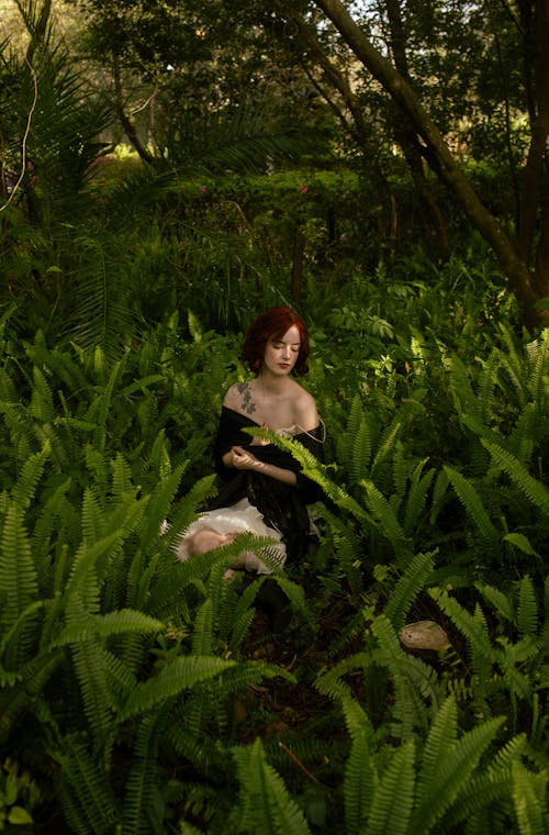 Woman Sitting among Fern