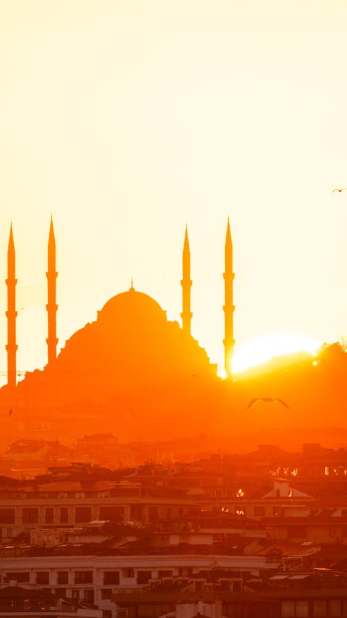 The sun is setting over the city of istanbul