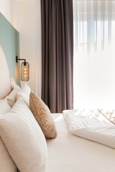 Bright minimalist bedroom featuring soft bedding and gentle sunlight. Ideal for tranquil settings.