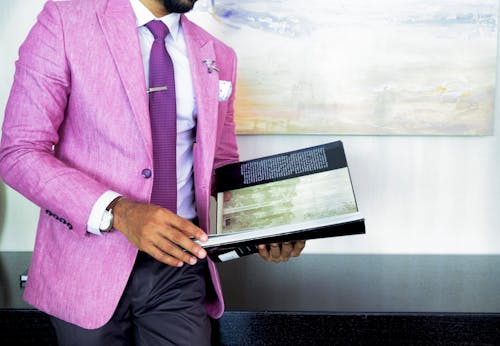 Free Man in Pink Suit Jacket Holding Book Stock Photo