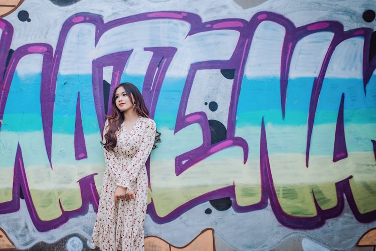 Woman Standing Against Mural