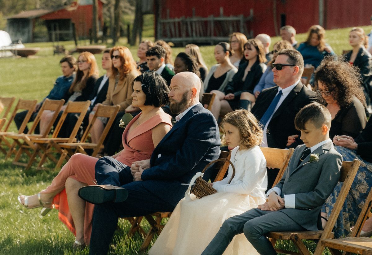 Guests watching an outdoor wedding ceremony