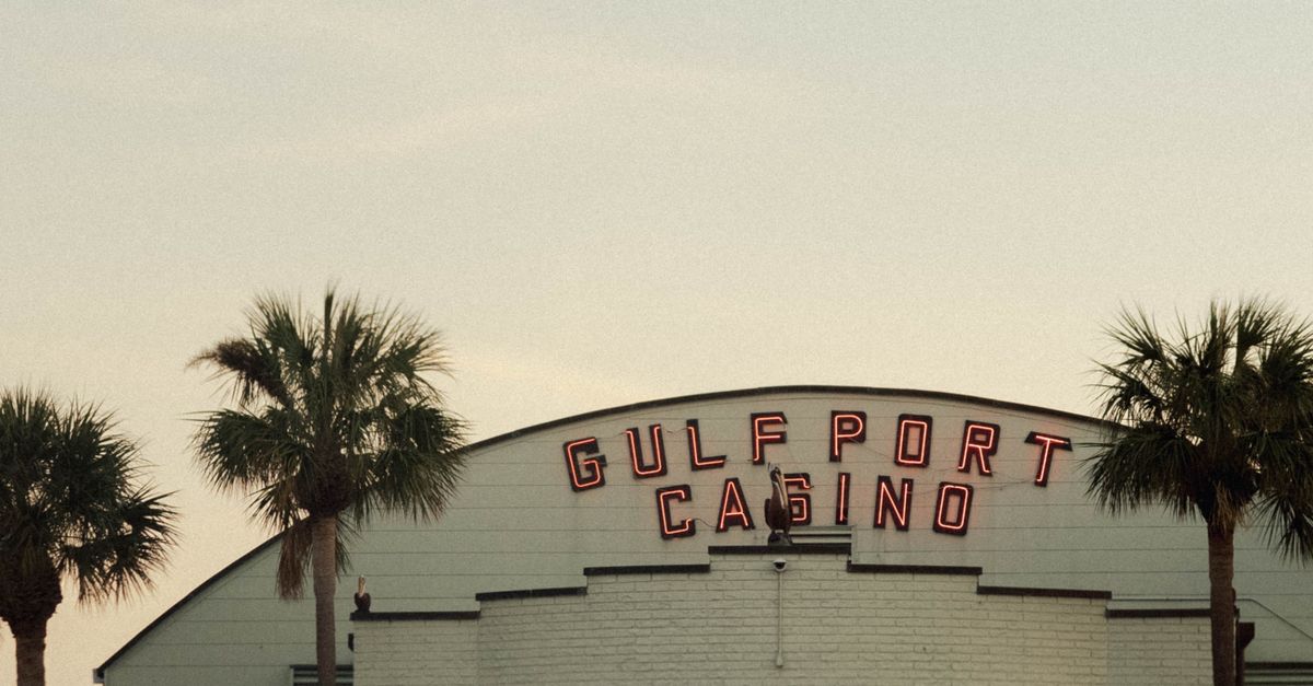 Photo by Taylor Thompson A view of the Gulfport Casino in Florida at sunset with palm trees.