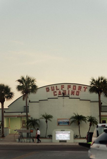 Photo by Taylor Thompson A view of the Gulfport Casino in Florida at sunset with palm trees.