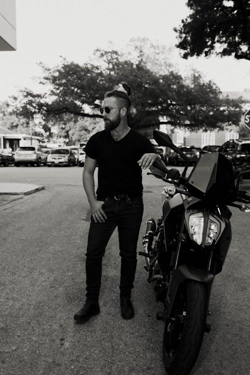 A man standing next to a motorcycle