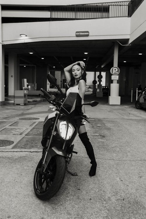 Woman in Over-the-knee Boots Posing on a Motorcycle