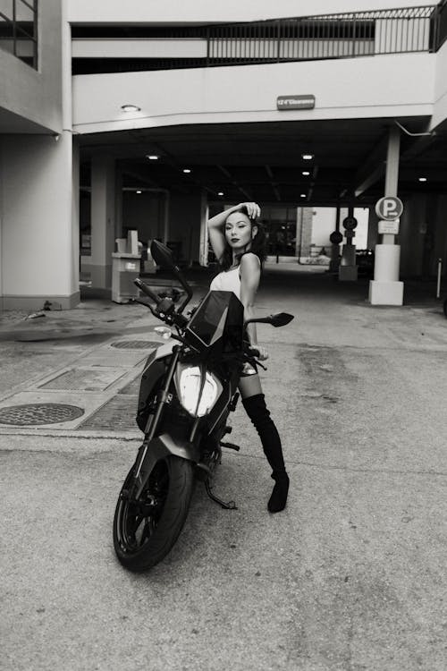 Model on a Motorcycle Posing in Front of a Parking Garage