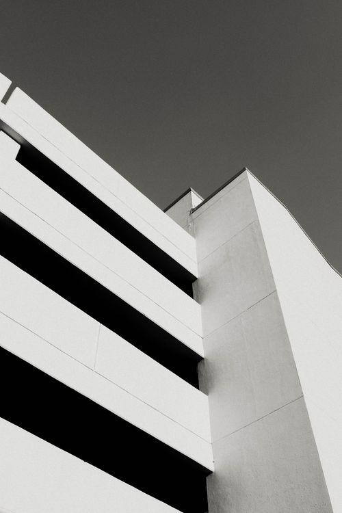 Free Black and white photo of a modern multi-storey parking lot with minimalist design. Stock Photo