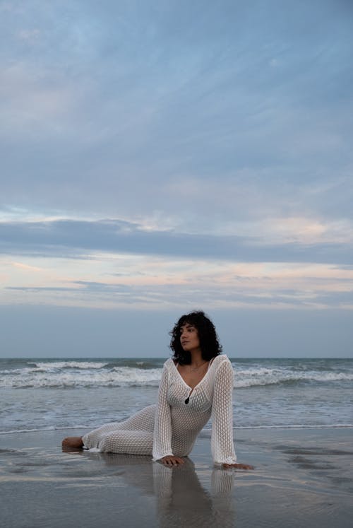 Brunette Woman Lying Down on Beach 