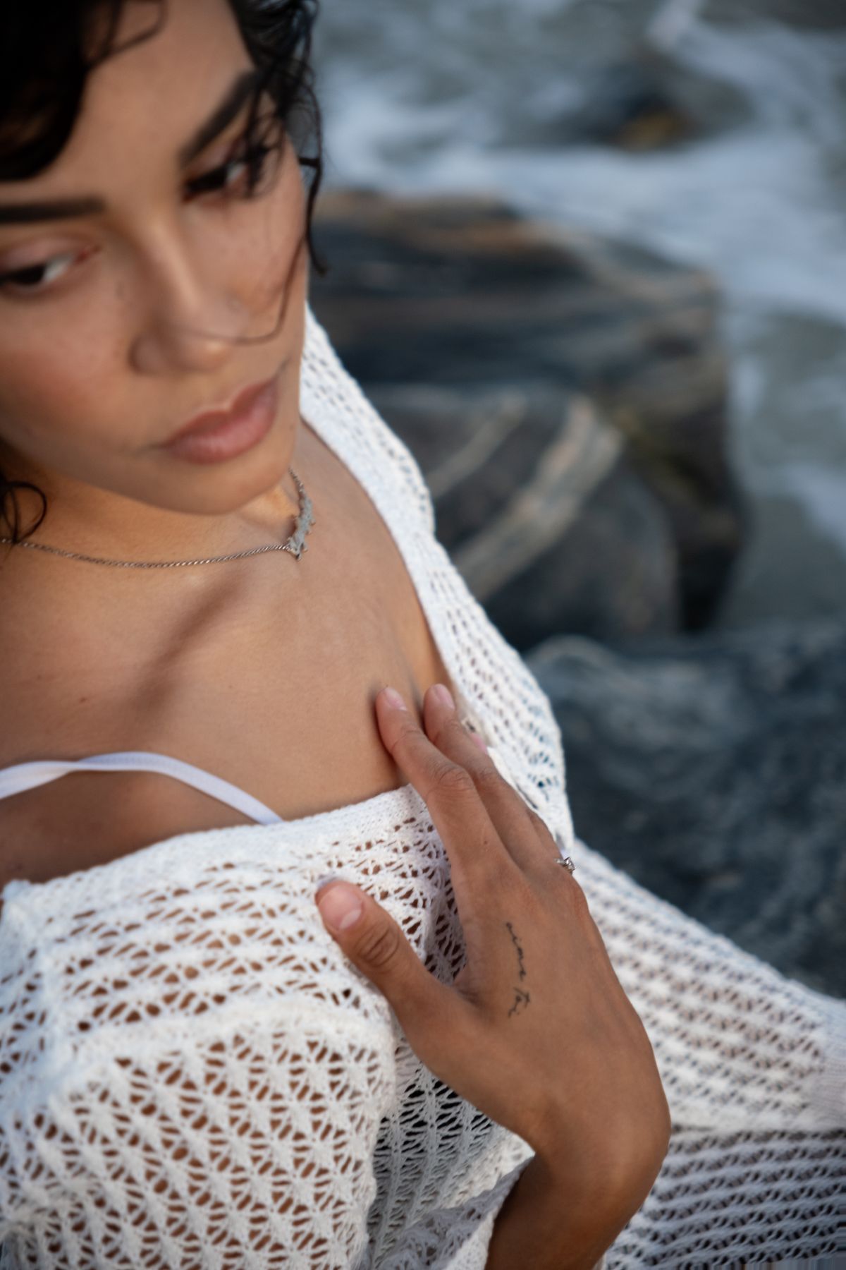 A portrait of a woman on a rocky beach — the handmade spirit of crochet