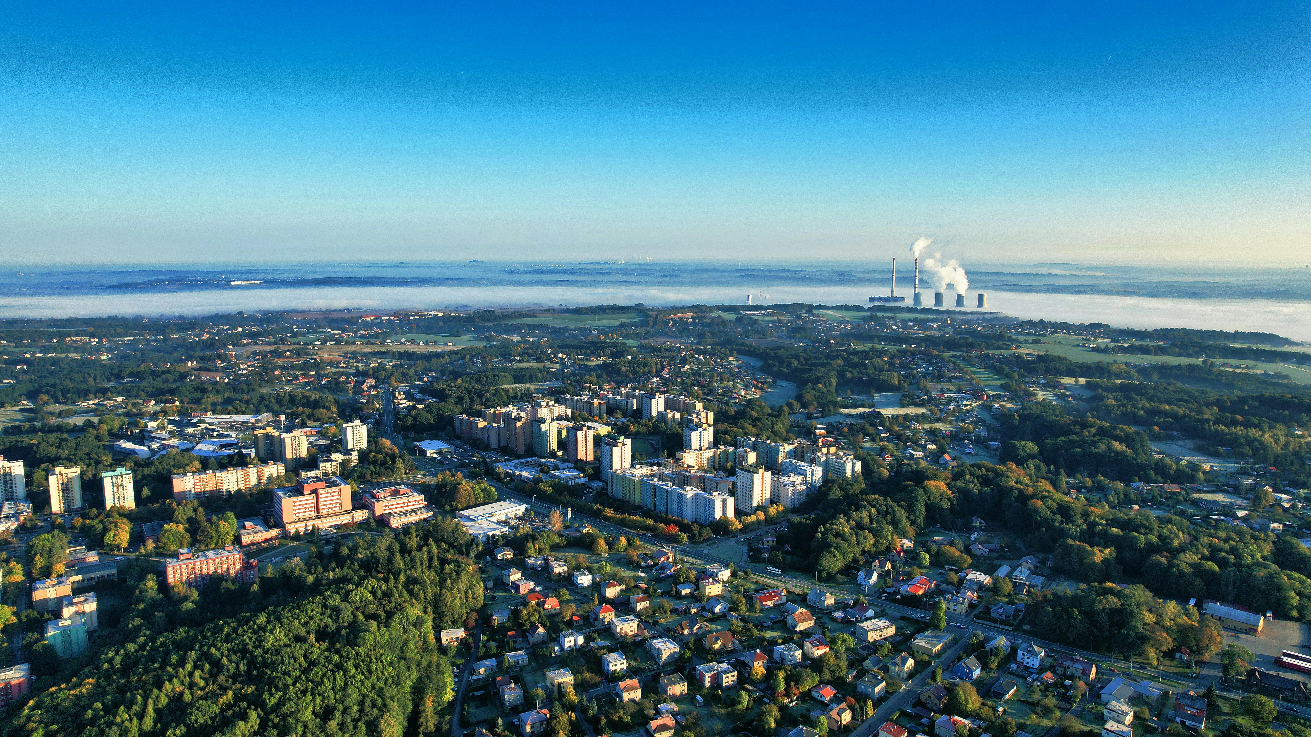 Aerial view of Orlová, Czechia, showcasing urban and industrial landscape in bright morning light.