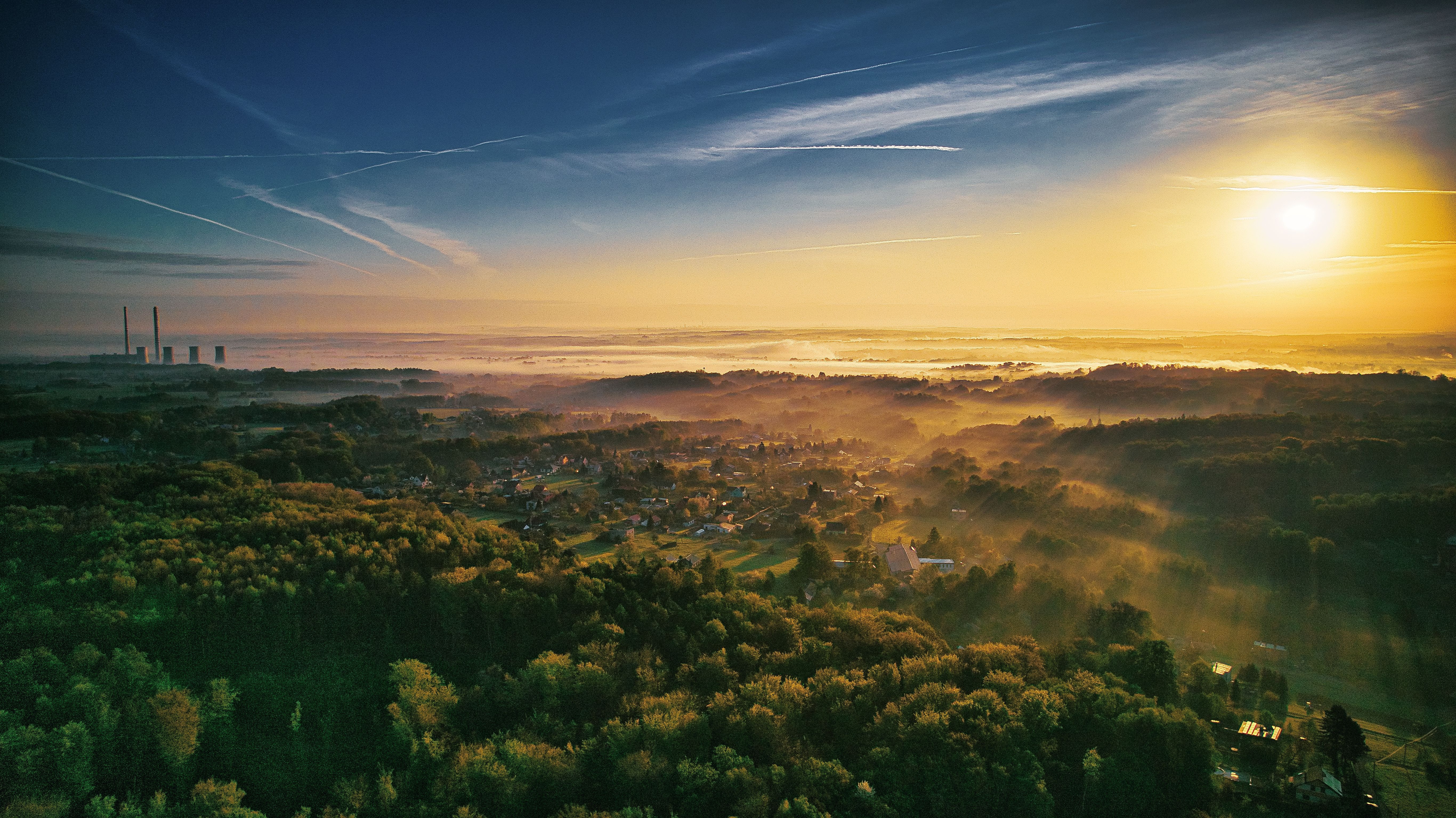 Breathtaking aerial view of Orlová, Czech Republic, at sunrise with vibrant countryside and distant power plant.