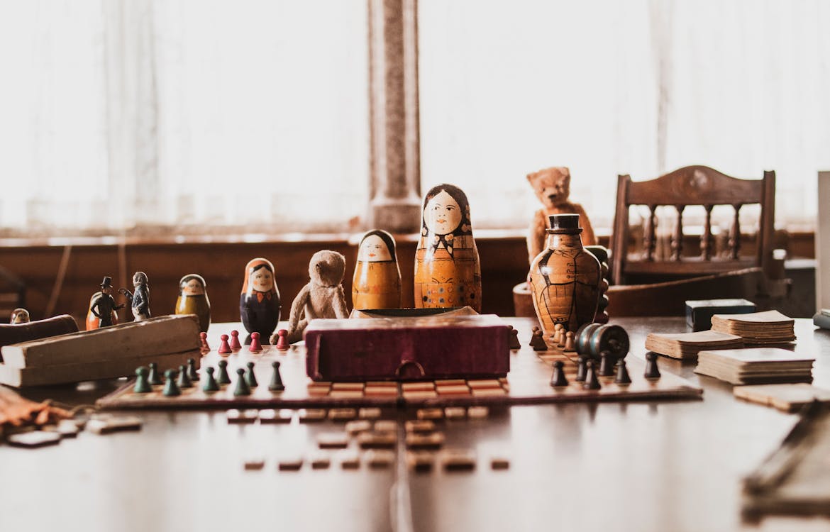 Free Brown-and-black Nesting Doll on Brown Wooden Table Stock Photo