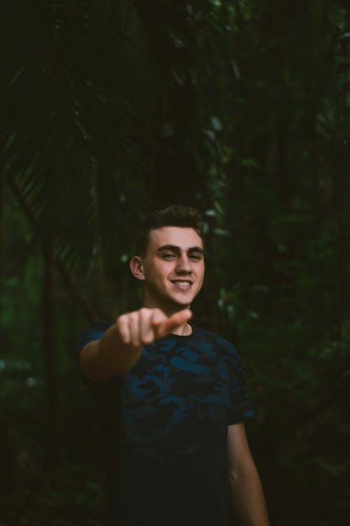 Photo of Smiling Man Pointing His Finger