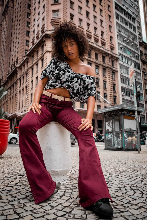 Woman Wearing Black-and-white Crop Top and Red Flare Jeans