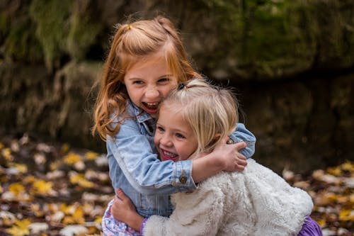 Free 2 Girls Hugging Each Other Outdoor during Daytime Stock Photo