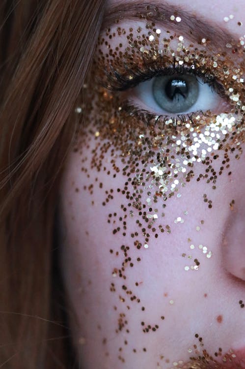 Free Close-Up Photo of Woman With Gold Glitters on Her Face Stock Photo