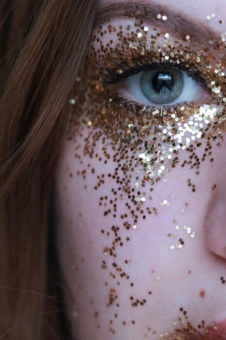 Close-Up Photo Of Woman With Gold Glitters On Her Face