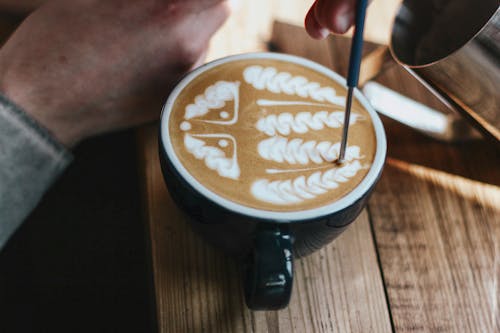Free Person Holding Black Ceramic Mug With Coffee Stock Photo