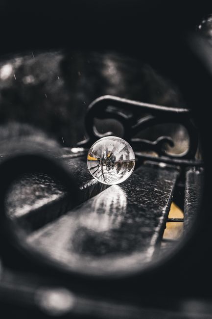 Artistic capture of a crystal ball reflecting its surroundings on a rainy day in Manchester.
