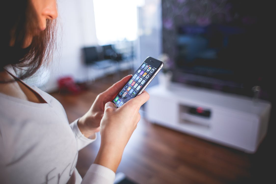 Free Woman Wearing White V Neck Shirt Using Space Gray Iphone 6 Stock Photo