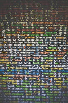 计算机屏幕上显示着充满活力的代码，展现了编程与软件开发的概念