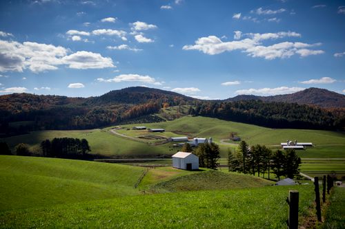 Free Charming rural landscape in North Carolina with lush green fields and blue skies. Stock Photo