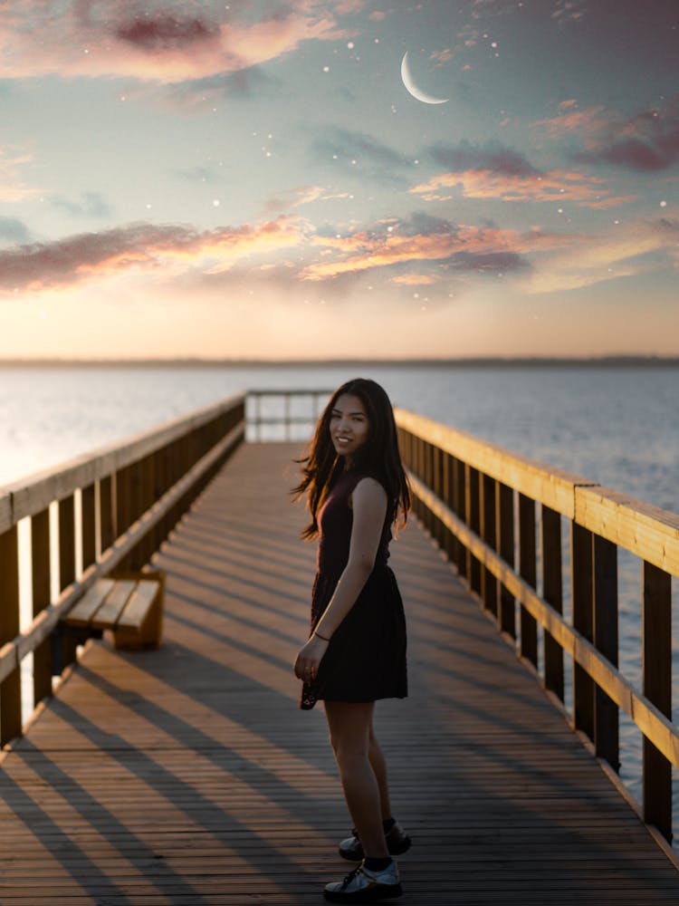 Woman Standing On Dock Wearing Black Dress