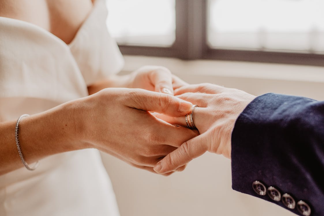 Free Woman Putting Ring On Person's Hand Stock Photo