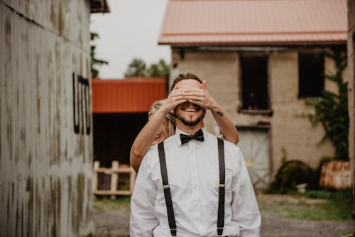 Free Woman Covering Man's Eyes Stock Photo