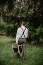 Man Carrying Black and Gold Briefcase