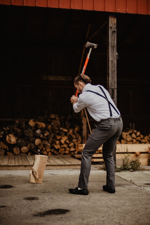 Man Wearing Grey Pants Holding Axe