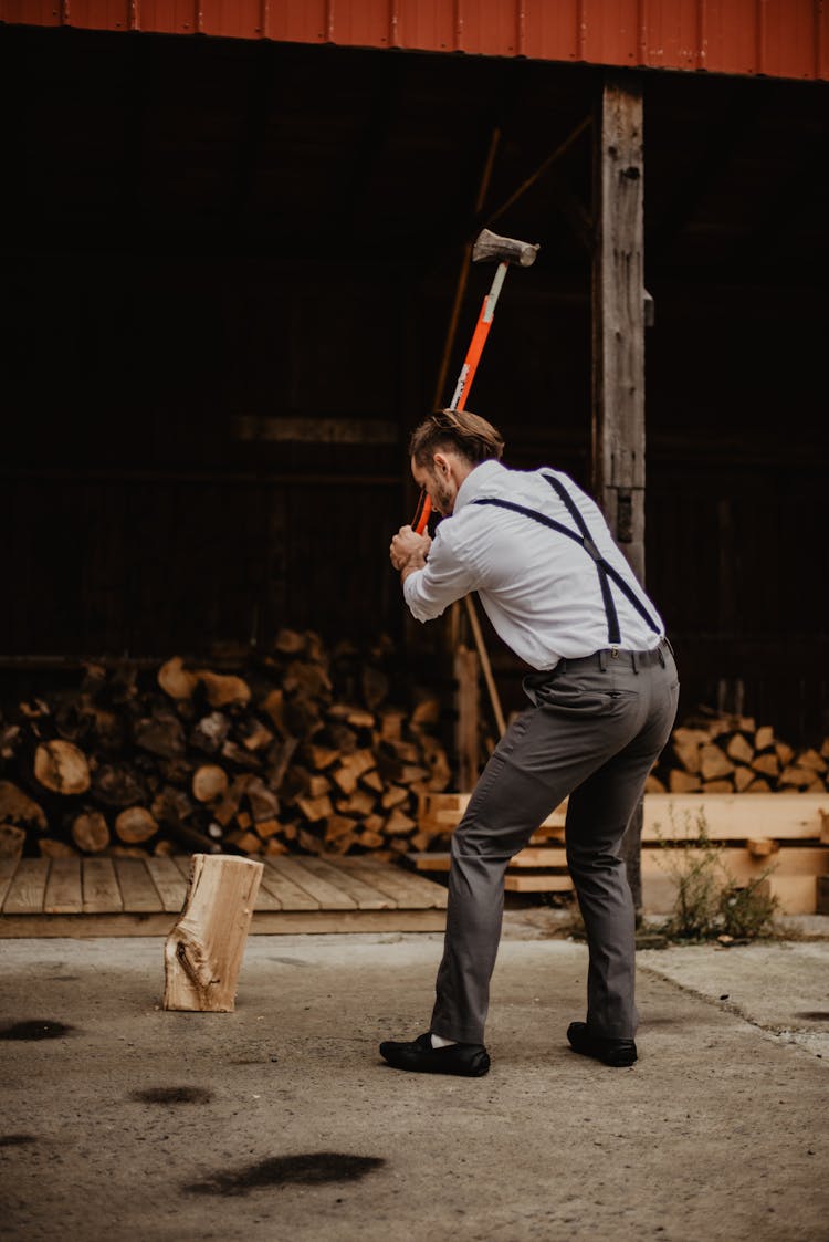 Man Wearing Grey Pants Holding Axe