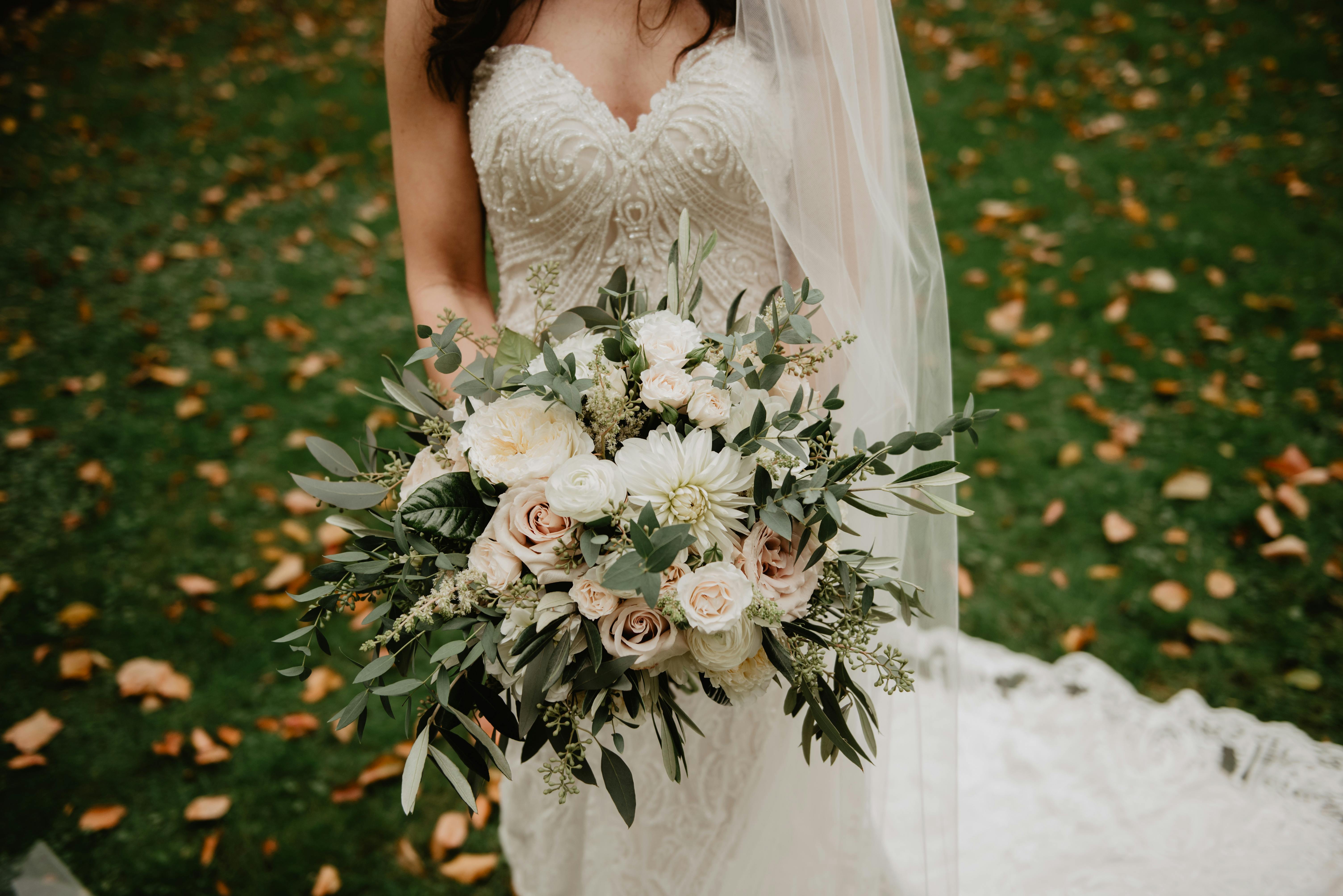 Woman Wearing White Wedding Dress With Bouquet Of Flowers Free