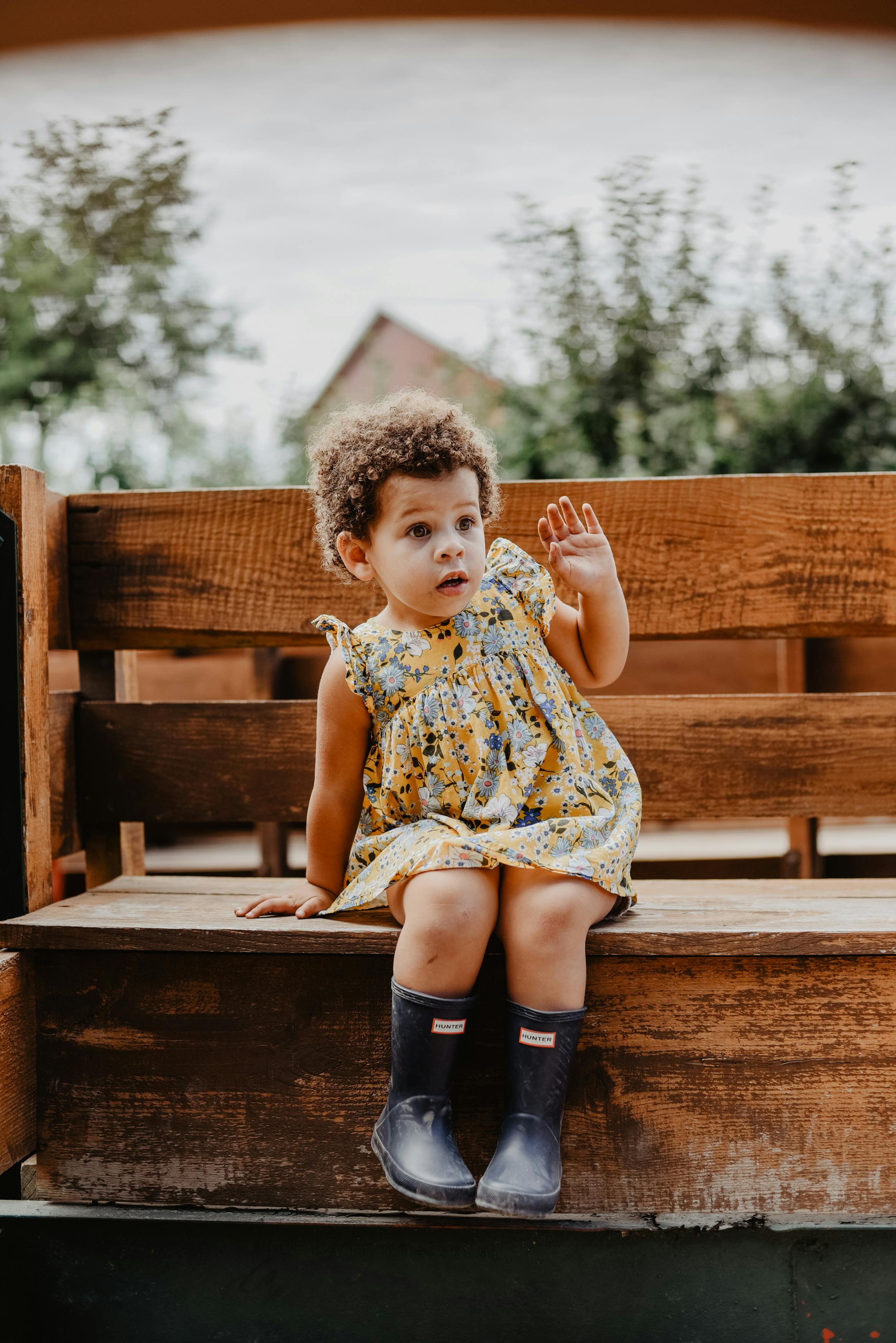 toddler sitting on bench