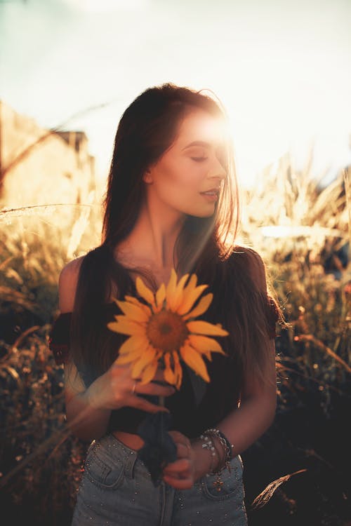 Free Woman Holding Sunflower Stock Photo