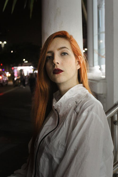 Woman Standing Outdoors during Nighttime