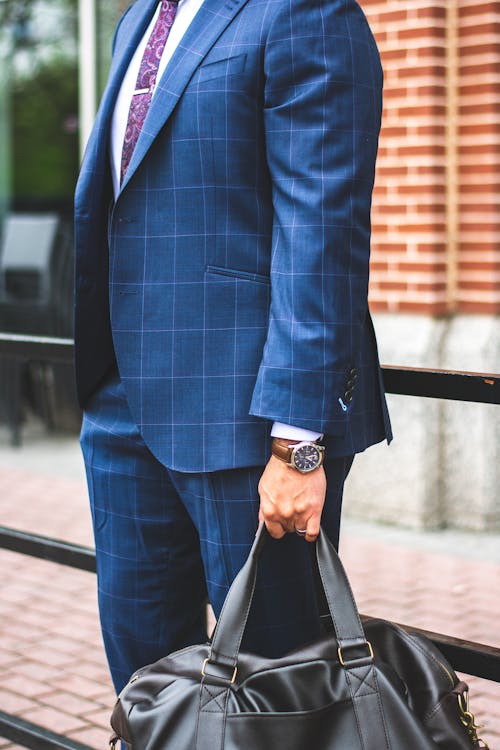 Person Wearing Blue Suit Jacket and Dress Pants Holding Tote Bag