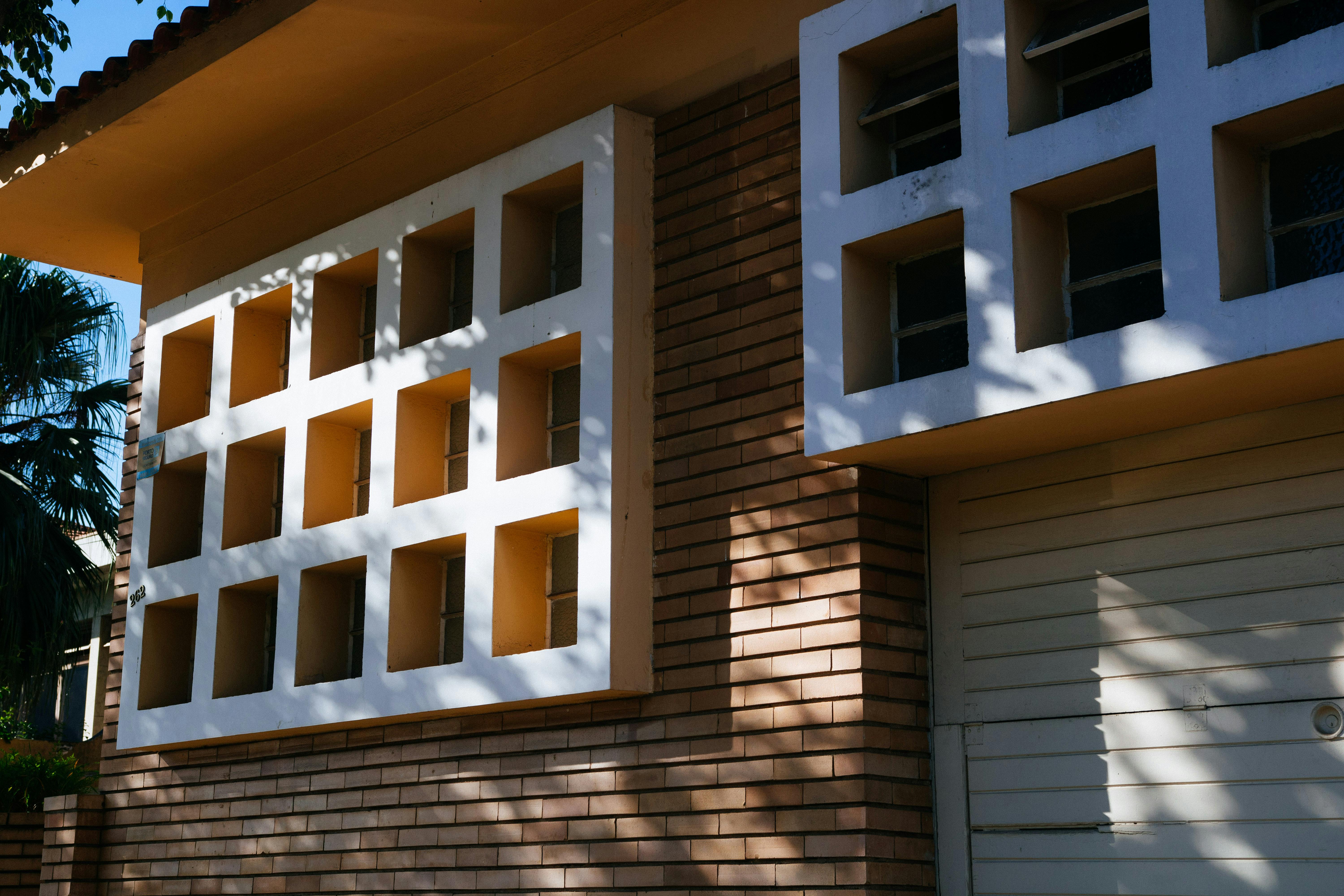 Brown Brick House White Multiframed Windows · Free Stock Photo