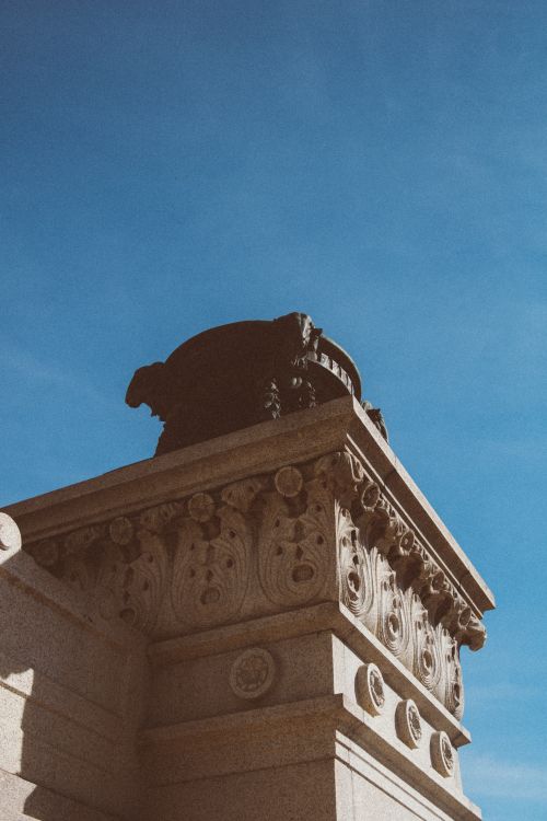 Free Intricate stone architectural detail captured against a clear blue sky. Stock Photo