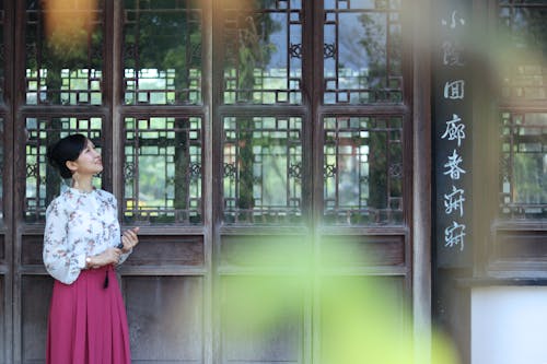 Woman Standing Near Window Looking Up