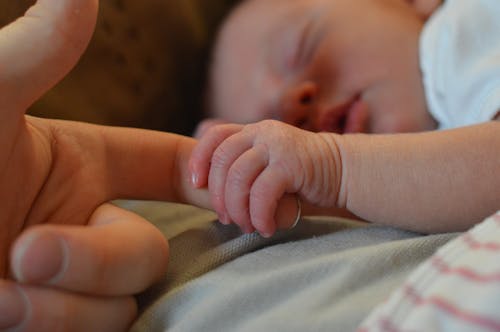 Free Baby Holding Human Finger Stock Photo