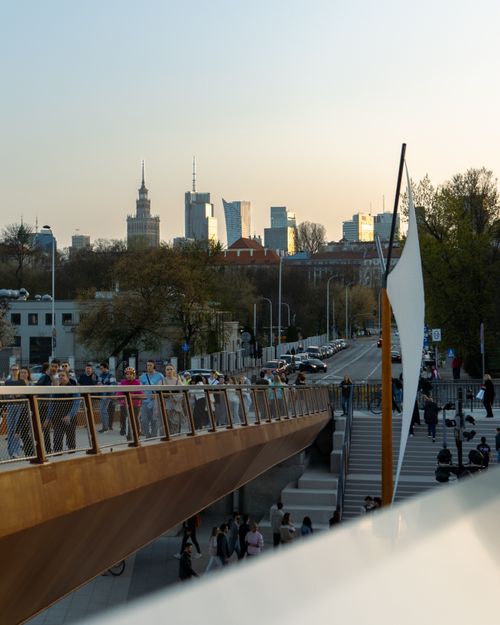 Free Cityscape with a modern footbridge and skyline in Warsaw during evening. Stock Photo