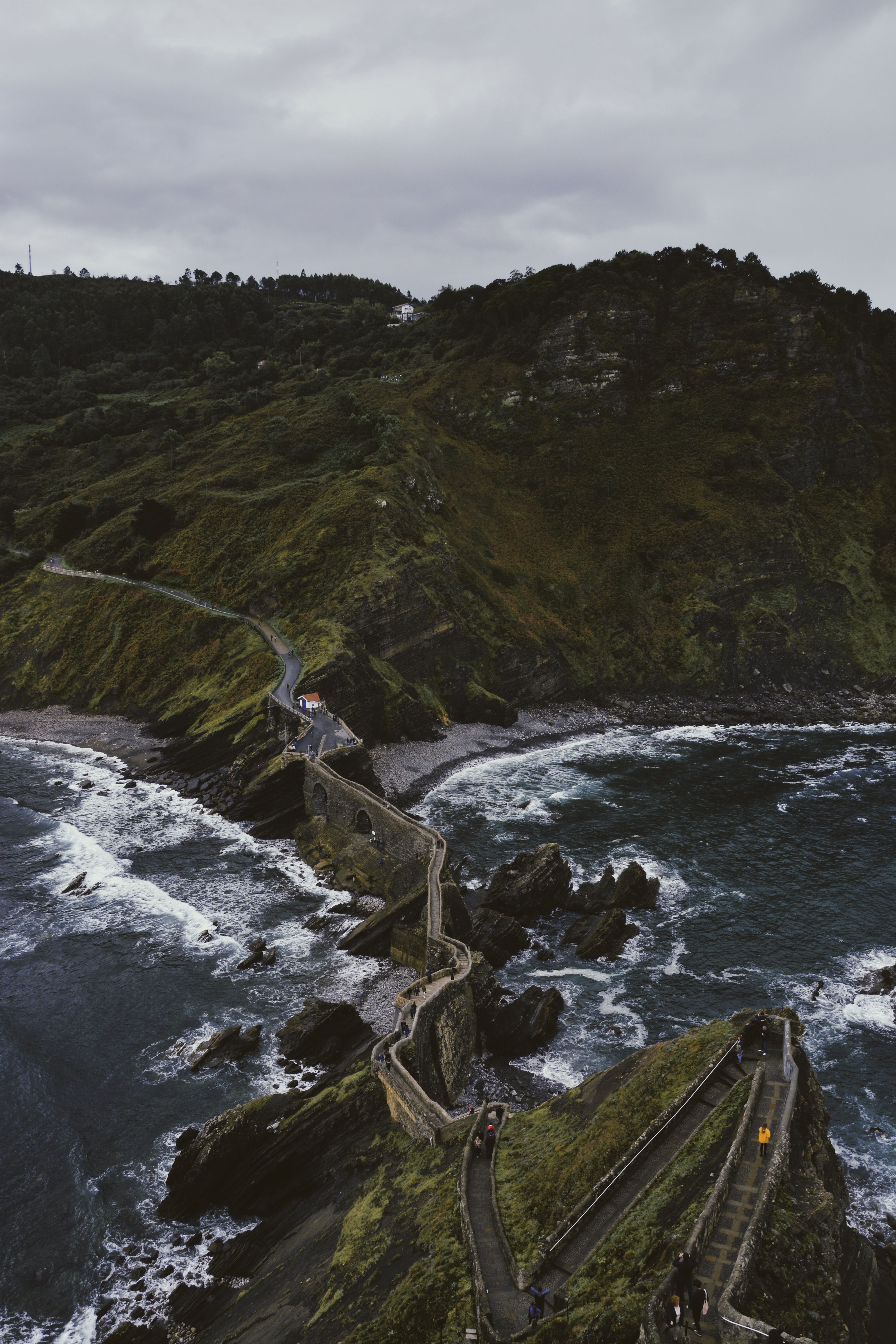 Explore the rugged coastal path leading to San Juan de Gaztelugatxe, a captivating travel destination.