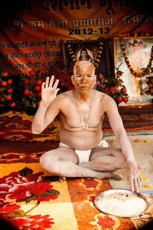 Free A devotee participates in a traditional Hindu ritual inside a colorful temple in Prayagraj, India. Stock Photo