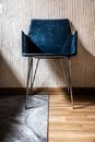 Blue Chair by the Beige Wall