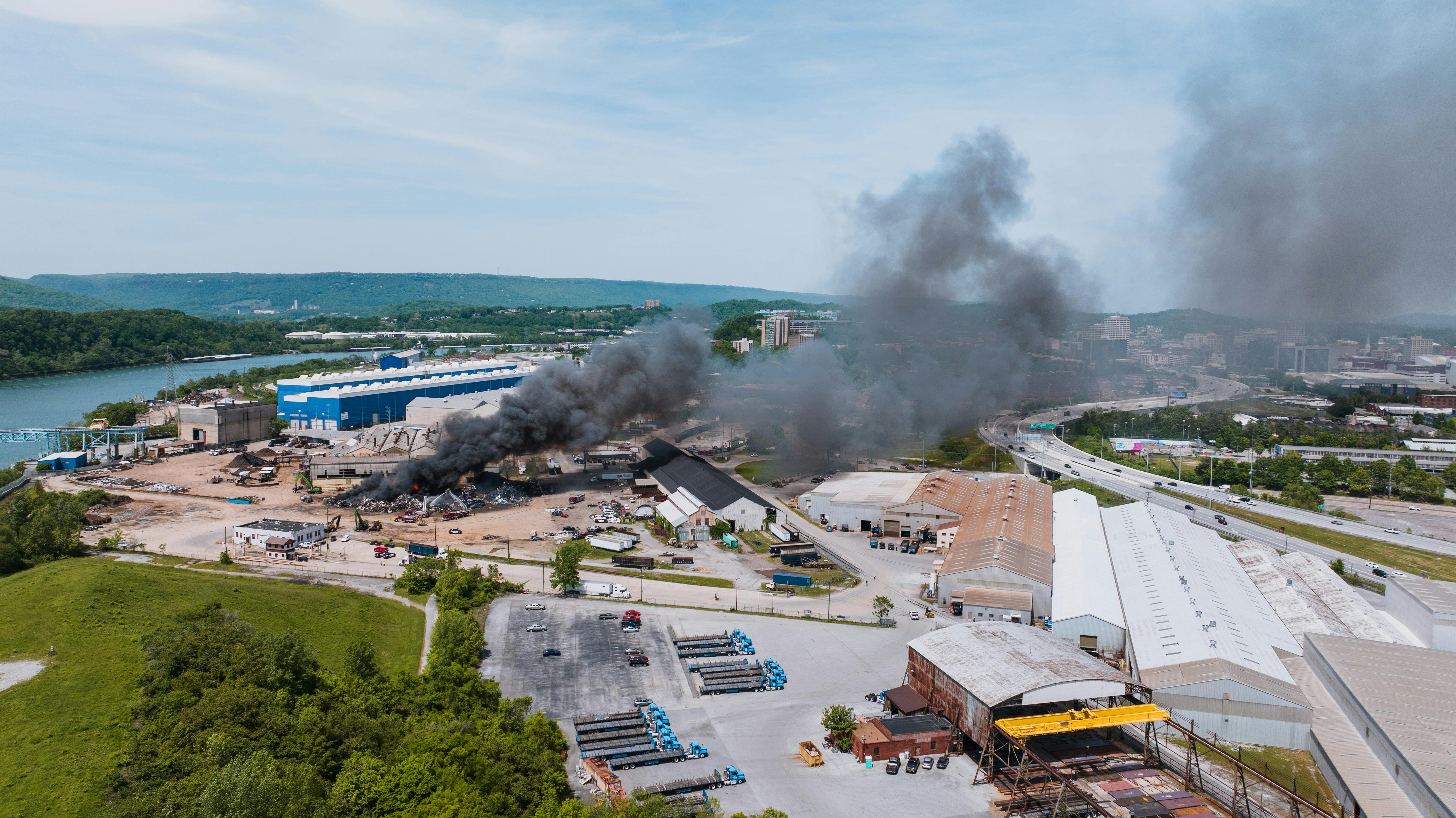 Aerial drone view of industrial fire with black smoke in Chattanooga, Tennessee.
